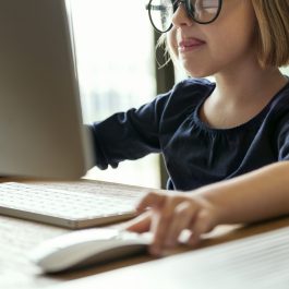 Little girl playing on a computer