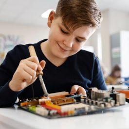 young-boy-repairing-an-electronic-component